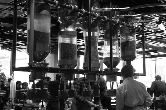 A black and white photo of people working in a factory