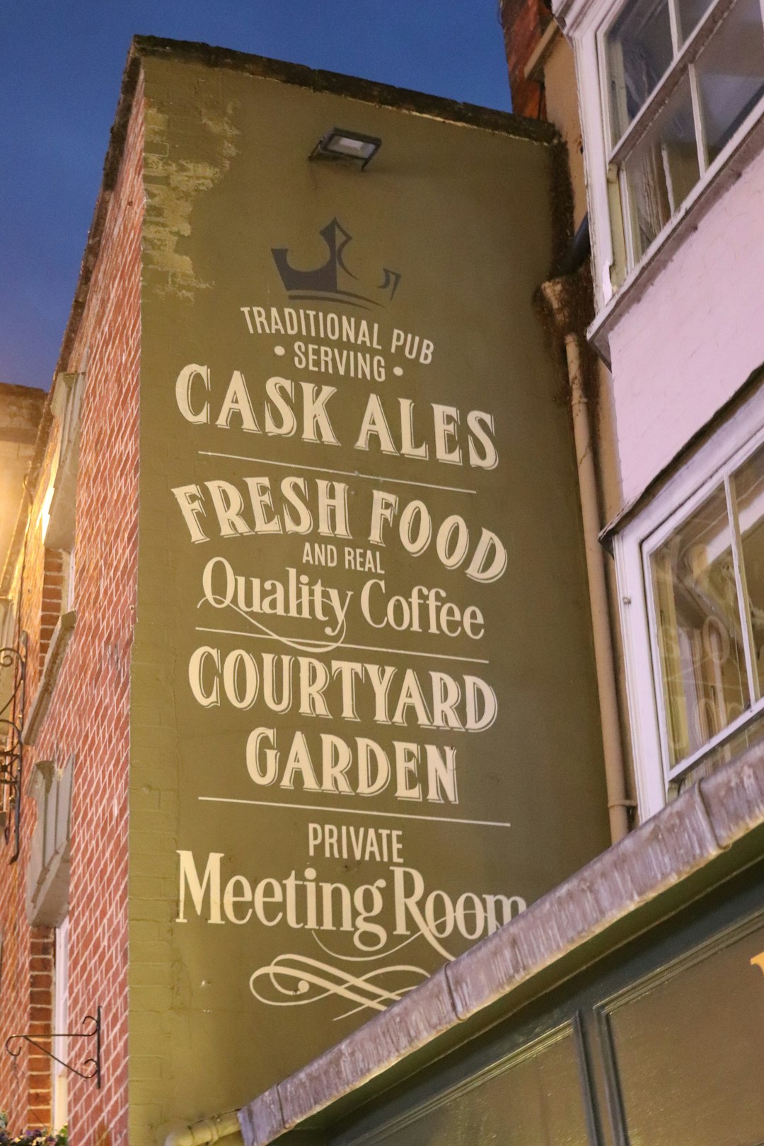 Traditional pub sign with "cask ales" and "fresh food".