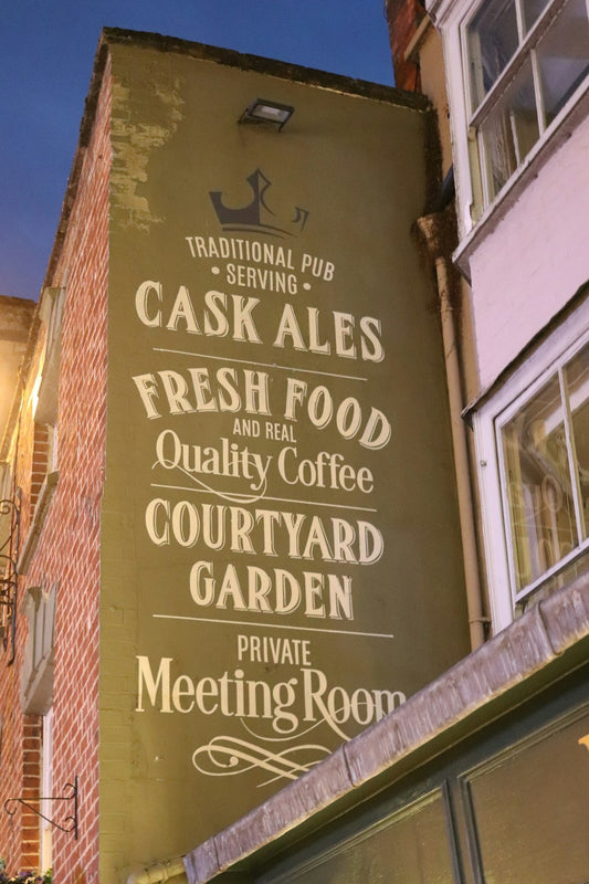 Traditional pub sign with "cask ales" and "fresh food".