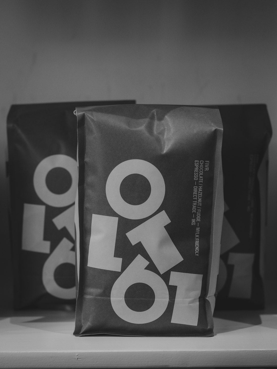 Two bags of coffee with large white logos