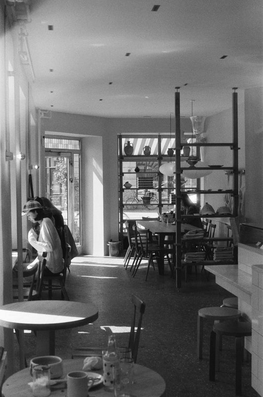 Interior of a cafe with tables and chairs.